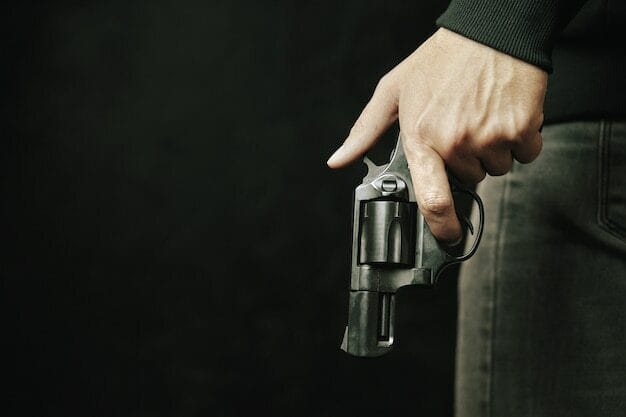 guy-with-gun-down-black-revolver-with-drum-in-mans-hand-armed-person-on-dark-background-firearms-for_72464-1717